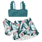 Girls forest green 3 piece bikini swim set with ruffle strap top and tropical leaf print bottoms with matching swim skirt.