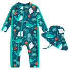 Toddler girls green dolphin print full coverage rash guard swimsuit with matching sun hat for beach, pool and outdoor water play.