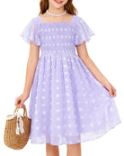 Girls lavender Swiss dot chiffon dress styled with a handbag accessory, featuring ruffle sleeves and elegant design for special occasions.