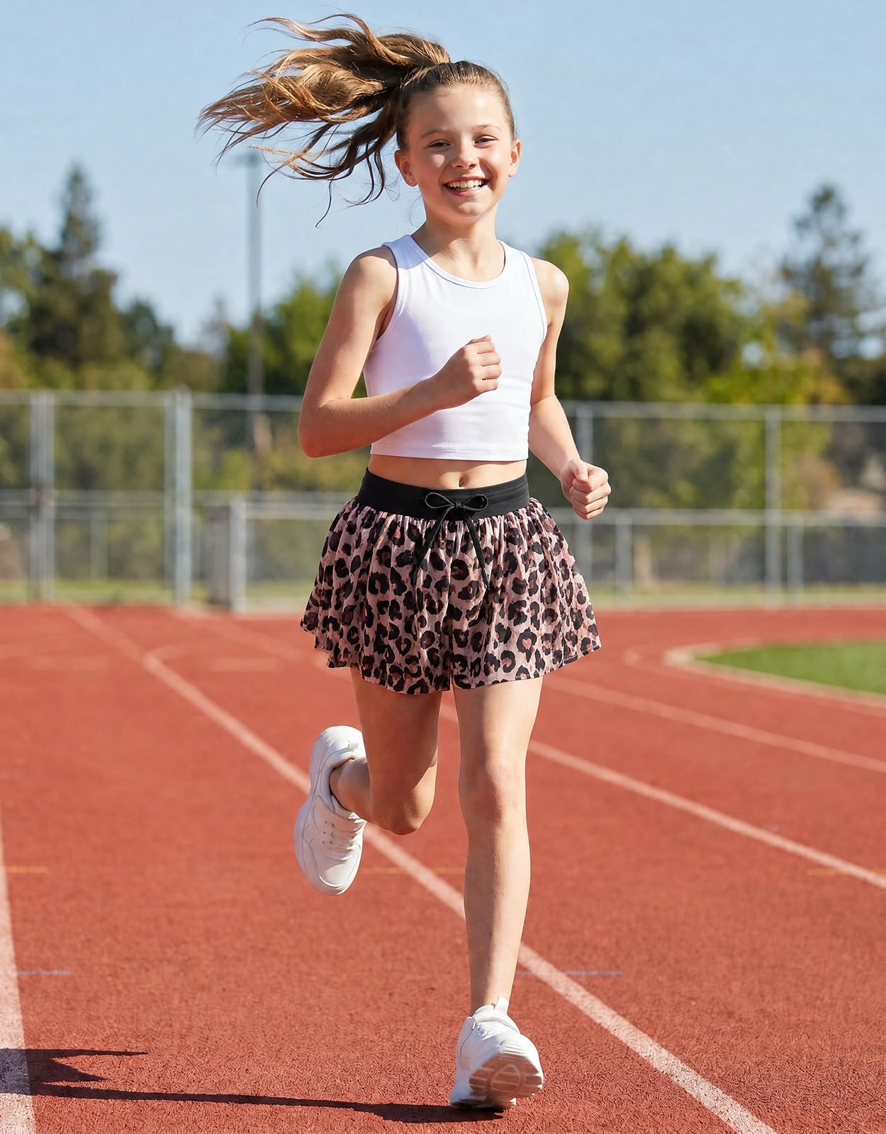 Girl wearing leopard sports shorts during outdoor activities, showing flexible fit and comfortable movement for active kids.