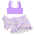 Girls light purple bikini swim set with ruffled shoulder top, lavender floral bottoms and coordinating ruffle swim skirt.