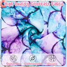 Close up of girls mermaid print swimsuit fabric with colorful scale pattern and soft stretch material.
