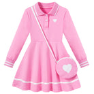 Girls pink long sleeve polo dress with white contrast trim and matching heart shoulder bag, featuring a flared skirt and classic collar design.