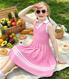 Girl wearing a color block polo dress during an outdoor activity, showing a comfortable A-line fit for summer days.