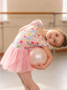 Young dancer wearing a sparkle ballet dress with ruffle sleeves and chiffon skirt during a dance performance practice.
