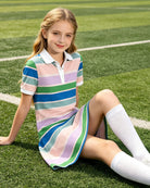 Girl wearing a striped collared dress while sitting outdoors, showcasing the relaxed fit and everyday comfort.
