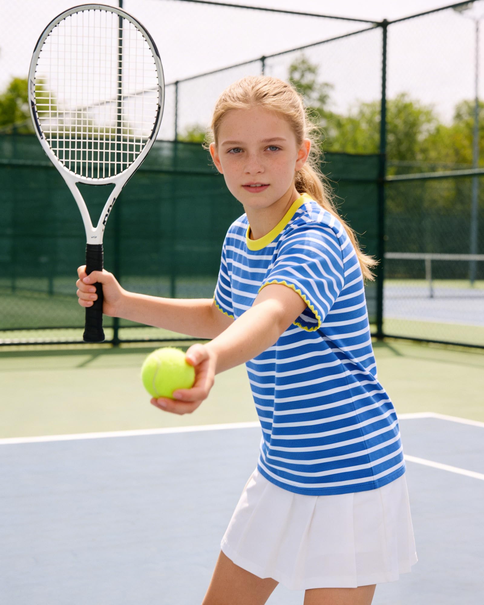 Girl wearing a striped short sleeve tee during outdoor activities, showing comfortable fit and playful summer style.