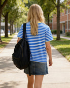 Girl wearing a striped cotton T shirt with a backpack, perfect casual school outfit for everyday wear.