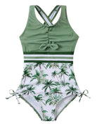 Girls green one piece swimsuit with cross back straps, palm tree print bottom, stretch fabric and comfortable fit for swimming, beach and summer activities.