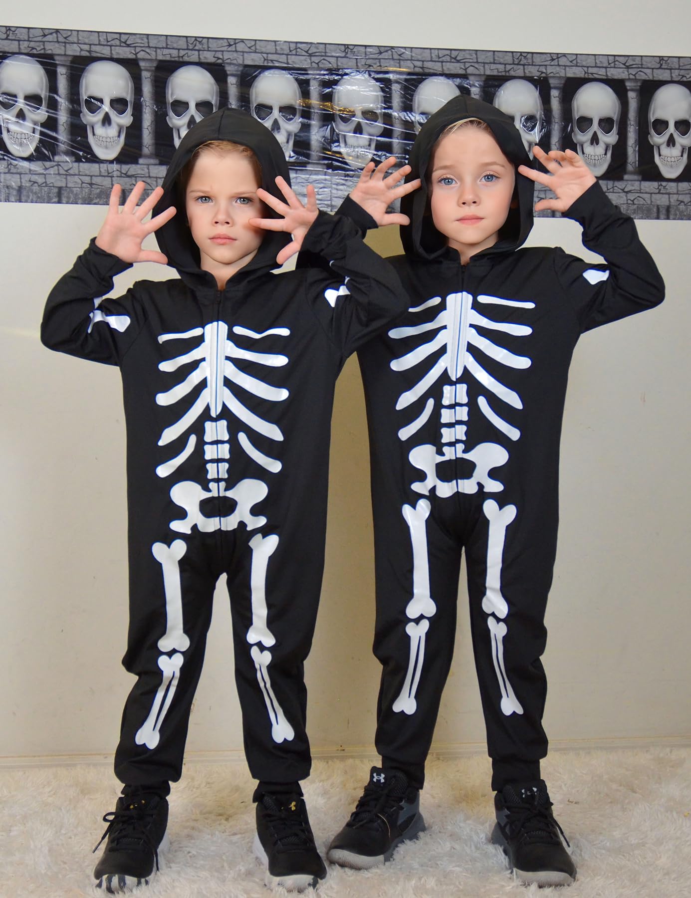 Kids wearing glow in the dark skeleton costumes together, showing the full-body Halloween outfit style for parties and trick or treating.