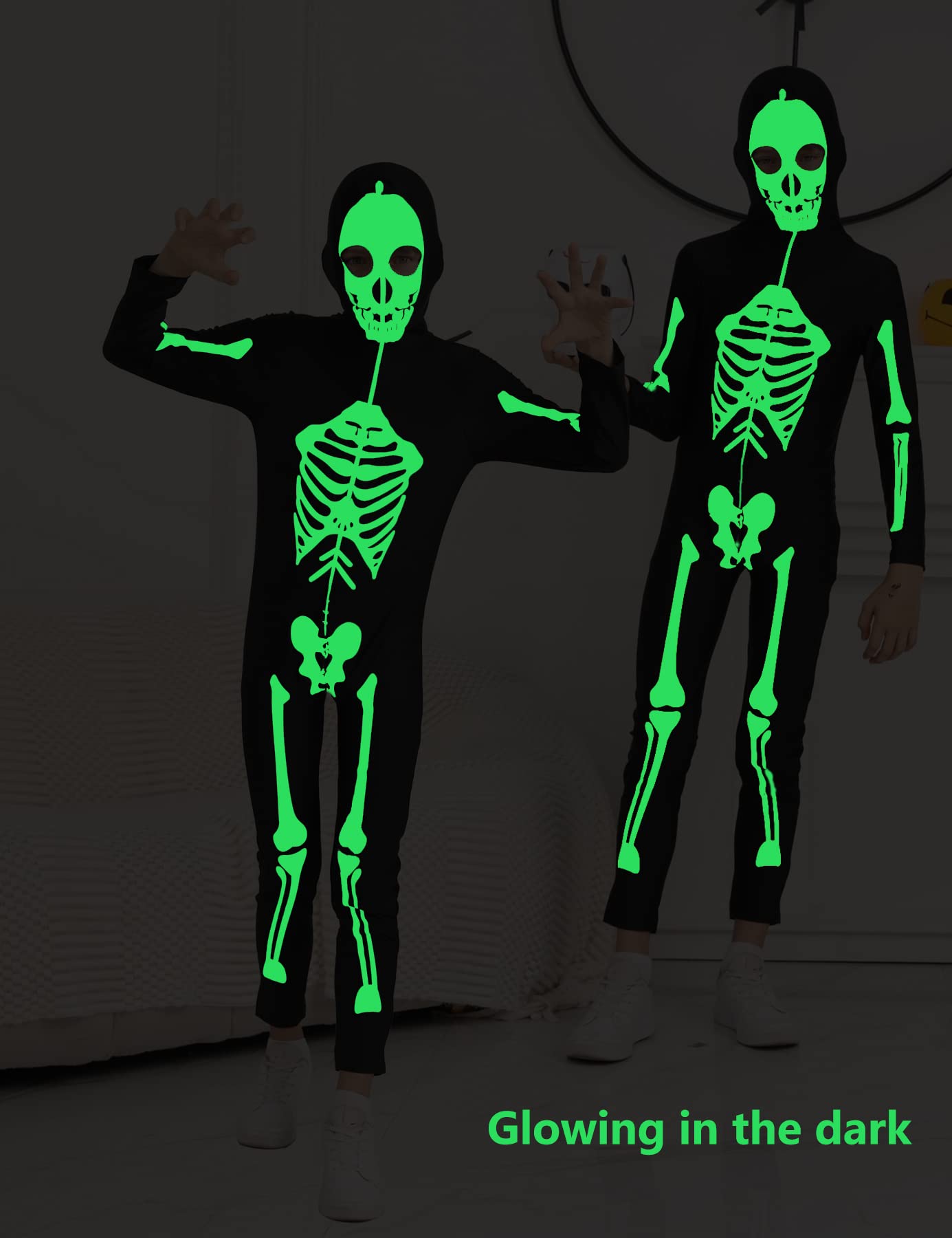 Kids wearing skeleton jumpsuits in the dark with glowing green bone prints, showing the luminous Halloween costume effect.