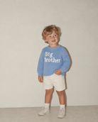 Little boy wearing a baby blue Big Brother sweater, showing the casual fit and cute sibling announcement style.