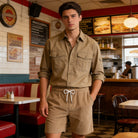 Man wearing linen blend drawstring shorts with a casual shirt, stylish summer outfit for travel, resort wear and everyday occasions.