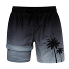 Men's black gradient 2-in-1 swim trunks with palm tree detail, built-in compression liner and drawstring waist for summer wear.
