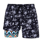 Men's black palm tree print swim trunks with built-in compression liner and tropical border design for summer beach wear.