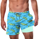 Man wearing blue crocodile print swim trunks with tropical vacation design