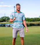 Man wearing a blue printed polo shirt outdoors, showing a comfortable casual style suitable for vacations and everyday activities.
