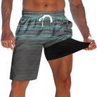 Men's teal grey striped swim trunks with built-in black compression liner, elastic drawstring waist and quick-dry outer fabric.