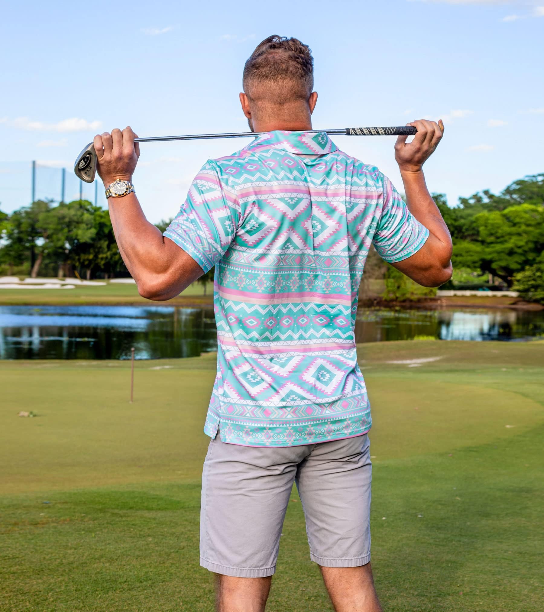 Man wearing a tropical printed polo shirt with casual shorts, versatile summer outfit for outdoor activities and leisure occasions.