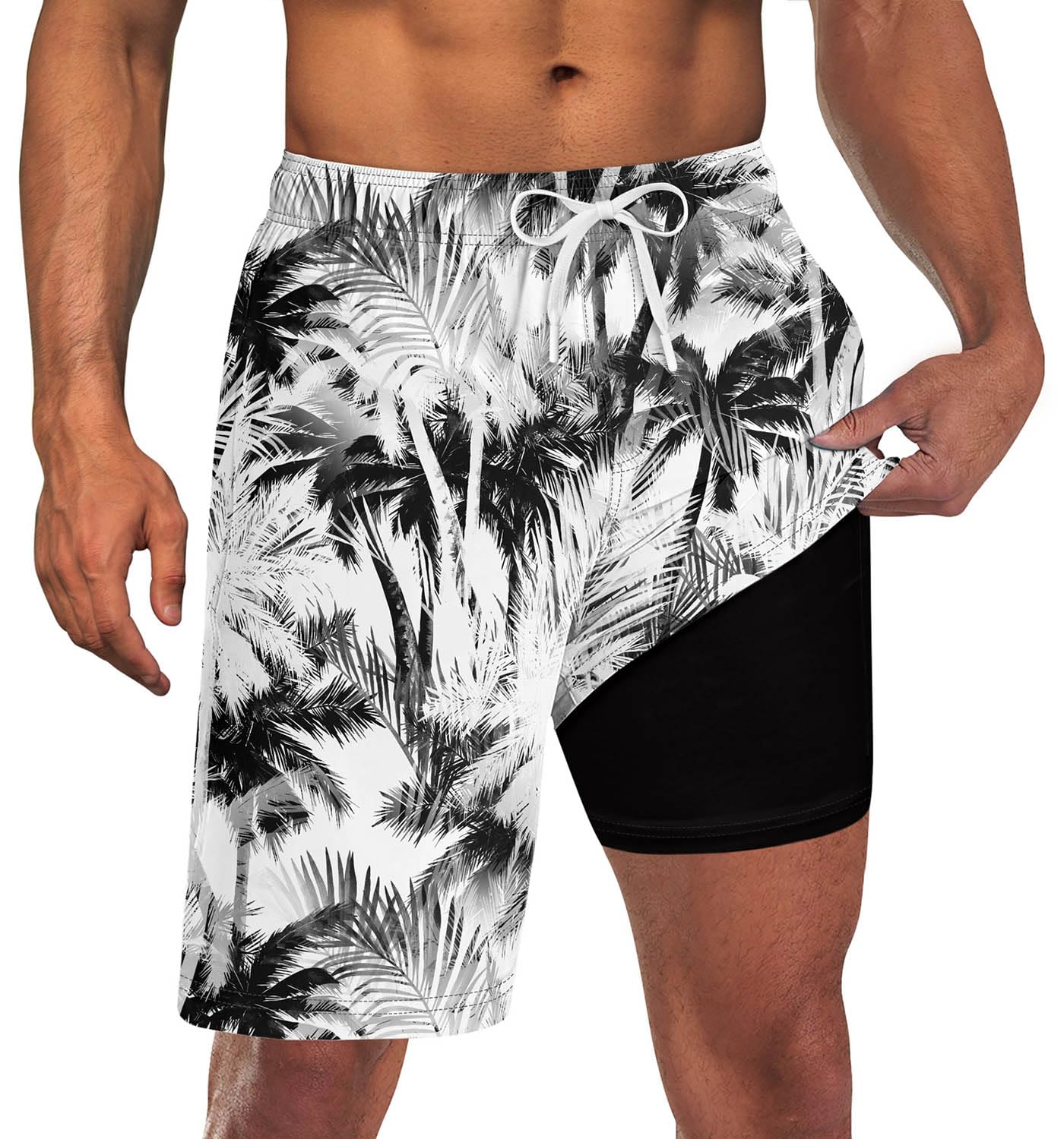 Men's white palm leaf print swim trunks with black compression liner and adjustable drawstring waist for beach and vacation wear.