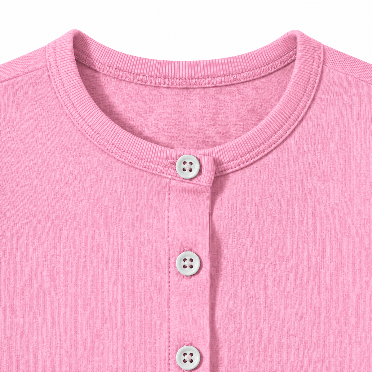 Close-up detail of the pink cardigan showing the round neckline, button closure, and soft knit texture.