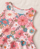 Close-up of the girls Pink Daisy Floral dress showing the sleeveless neckline and colorful pink, blue and green flower print.