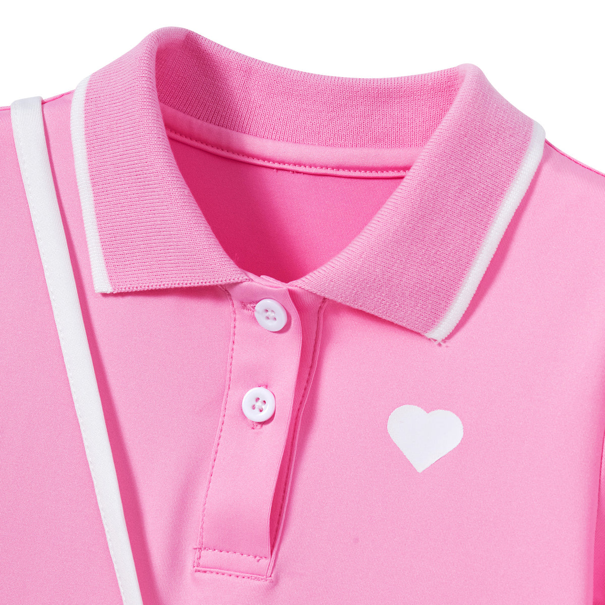 Close-up of the pink girls polo dress showing the contrast-trim collar, button placket and small white heart detail on the chest.