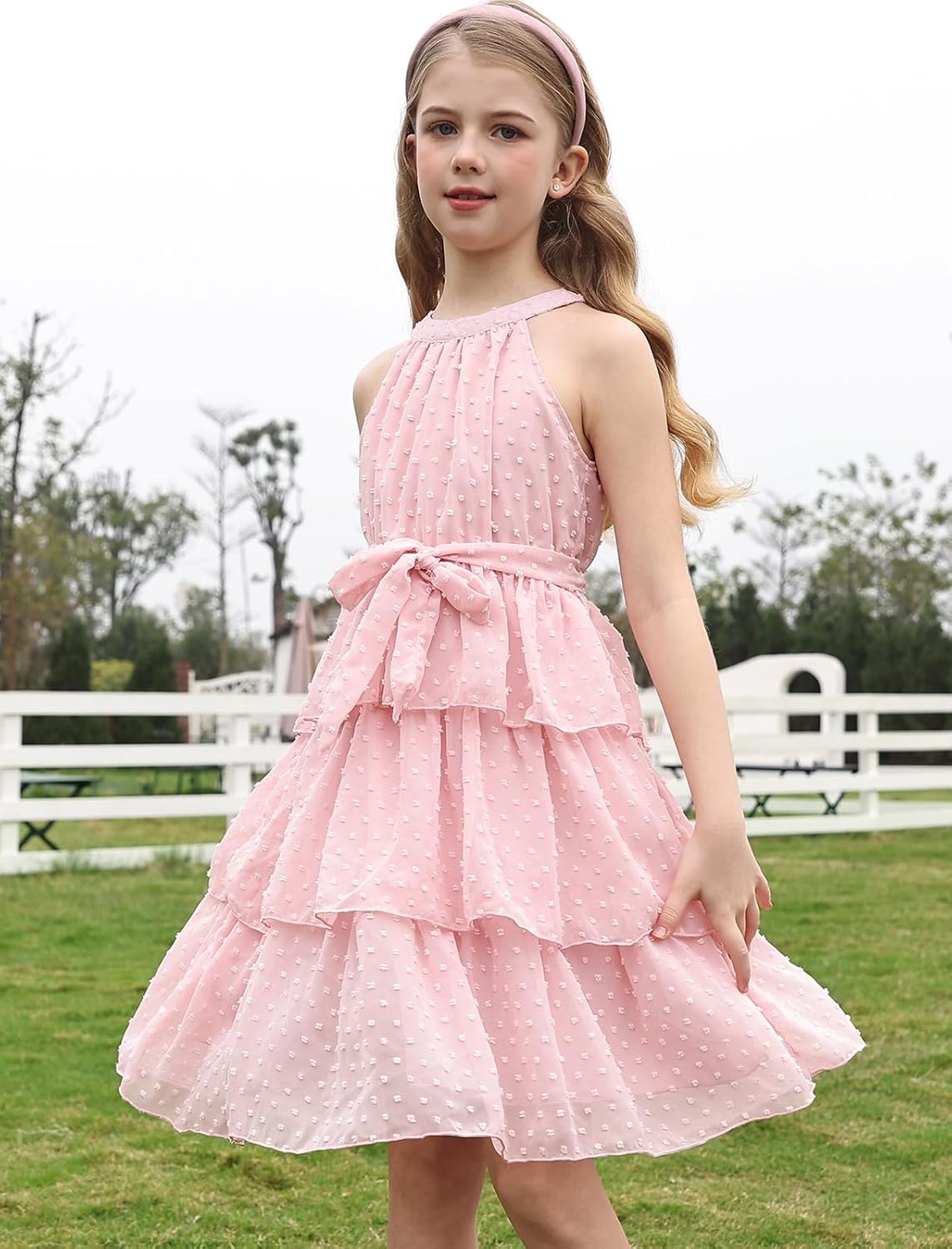 girl wearing elegant pink swiss dot tiered princess dress for birthday parties weddings and family celebrations