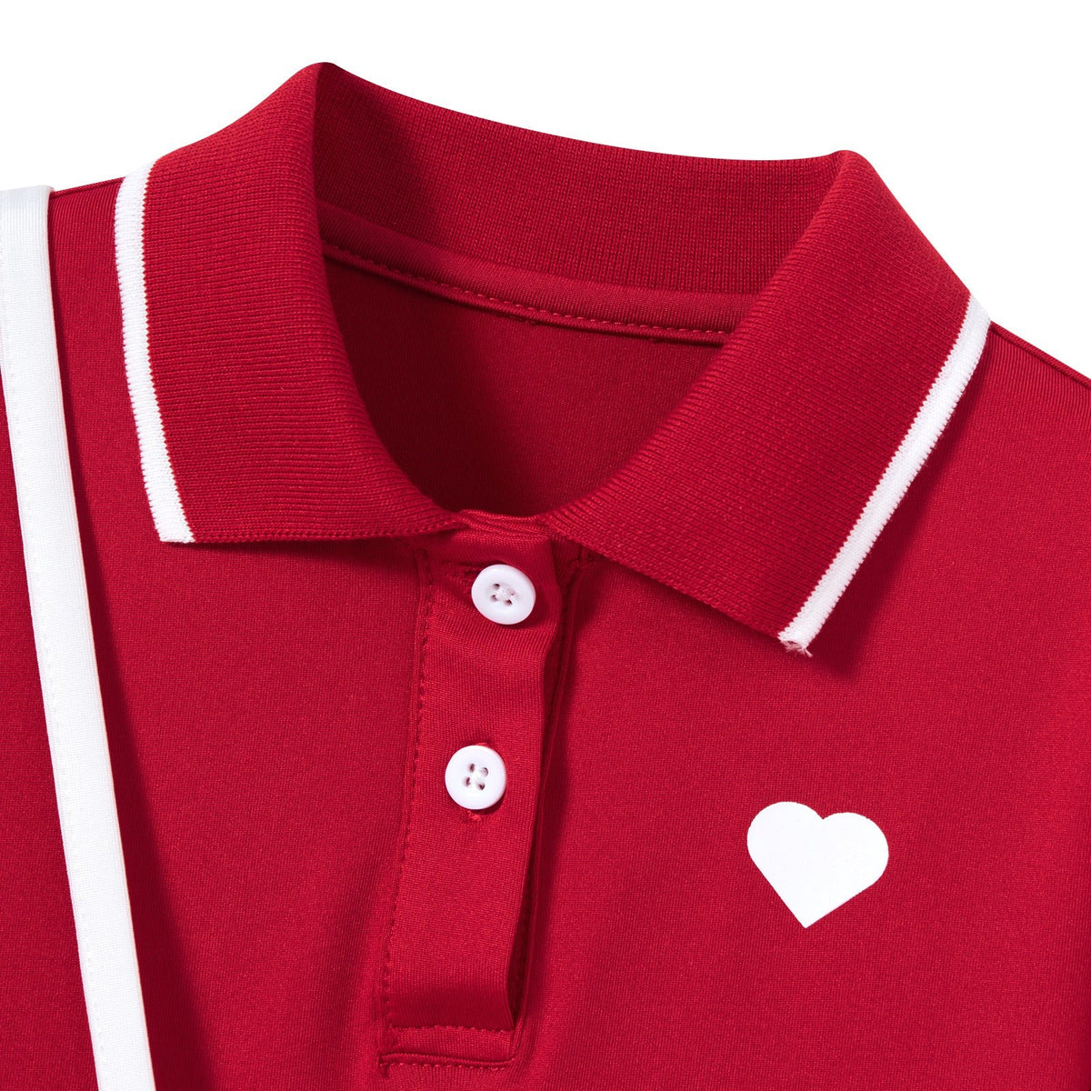 Close-up of the red girls polo dress showing the polo collar, button neckline, white trim and heart detail on the chest.