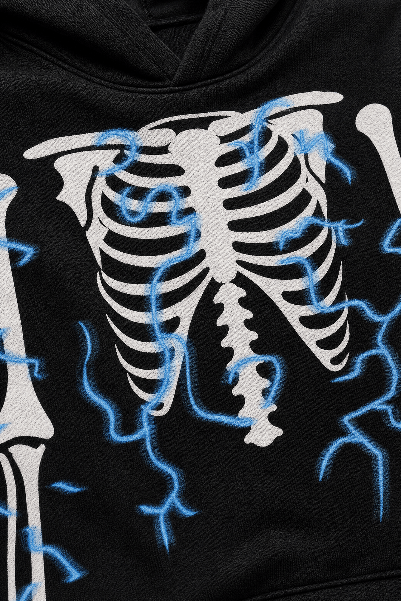 Close-up of kids black skeleton costume showing the detailed rib cage and bone print on the soft stretch fabric.