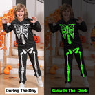 Close-up details of kids skeleton costume set showing glow in the dark print, hood design, matching pants and Halloween outfit features.