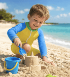 Toddler boy wearing a yellow and blue rash guard swimsuit while playing on the beach, designed for comfortable summer water activities.