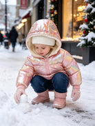 Toddler girl wearing a shiny puffer coat during a winter outing, showing the lightweight fit and warm outerwear design.